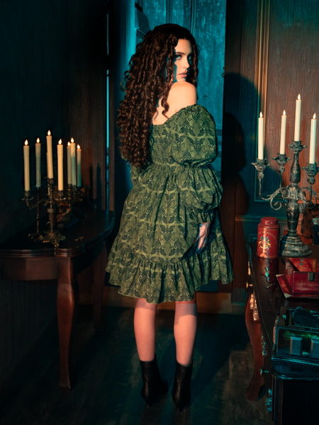 The Allerdale Moth Wallpaper Babydoll Dress is a key to a secret garden, its olive hue and moth pattern a map to hidden realms. This dress, airy and ethereal, offers a glimpse into a world where gothic beauty blooms in the most unexpected places, inviting the wearer to lose themselves in the mystery of the night.