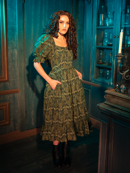 In the CRIMSON PEAK™ Allerdale Moth Wallpaper Babydoll Dress, the whisper of olive fabric against skin is like a secret shared in the dark. The moths, symbols of transformation, weave a tale of mystery and enchantment, inviting the wearer to explore the depths of their own soul. This dress is not just a garment; it's an experience.