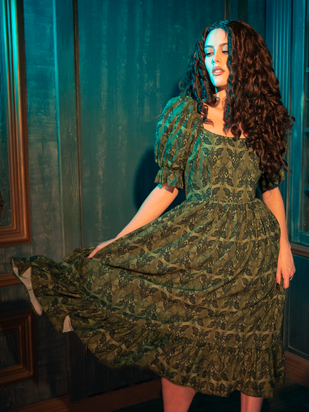 The CRIMSON PEAK™ Allerdale Moth Wallpaper Babydoll Dress in Olive is a haunting melody woven into fabric, its pattern inspired by the whispering walls of Allerdale Hall. The olive hue, deep and enigmatic, serves as the perfect canvas for the intricate moth design, symbolizing transformation and the fleeting nature of beauty. This dress, with its ethereal babydoll silhouette, invites you to embrace the mystery and allure of gothic elegance.
