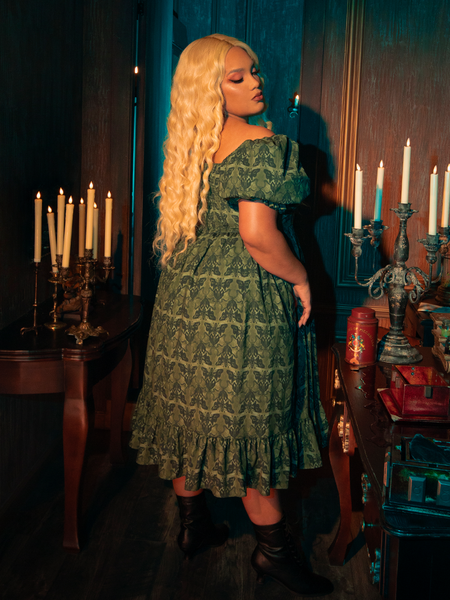 The Allerdale Moth Wallpaper Babydoll Dress is a key to a secret garden, its olive hue and moth pattern a map to hidden realms. This dress, airy and ethereal, offers a glimpse into a world where gothic beauty blooms in the most unexpected places, inviting the wearer to lose themselves in the mystery of the night.