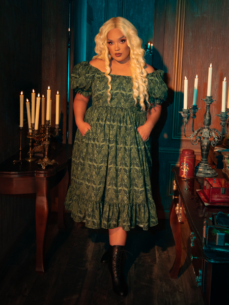 The whispering wings of moths, captured in the intricate design of the Allerdale Moth Wallpaper Babydoll Dress, evoke a sense of ephemeral beauty. The olive color, rich and earthy, grounds the ethereal design, creating a piece that is as grounded as it is whimsical. This dress is a testament to the allure of the Gothic, inviting the wearer to explore the depths of their own imagination.