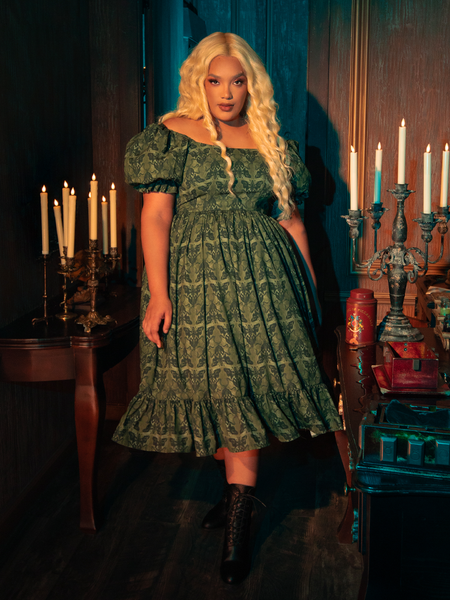 The CRIMSON PEAK™ Allerdale Moth Wallpaper Babydoll Dress blends the natural and the supernatural, its olive fabric adorned with moth motifs that speak to the gothic soul of nature. This dress, with its simple yet captivating design, is a reminder of the beauty that thrives in the shadows, waiting to be discovered.
