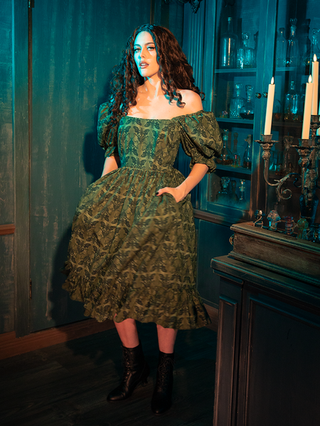 The Allerdale Moth Wallpaper Babydoll Dress casts the wearer in mystic shadows, its olive hue and moth motifs creating an aura of intrigue. This dress, with its fluid lines and ethereal silhouette, is a testament to the power of the gothic aesthetic, inviting onlookers into a world where mystery reigns supreme.