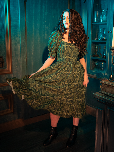 The Allerdale Moth Wallpaper Babydoll Dress, with its soft olive hue and haunting moth print, invites you into a gothic reverie. The babydoll cut, both innocent and provocative, whispers tales of forgotten mansions and secret gardens. Wearing this dress, you become part of a narrative that celebrates the beauty found in darkness.
