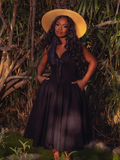 The Ambrosia Dress in Black is a hauntingly beautiful piece. Its sleek design and flowing fabric create an air of mystery and enchantment, perfect for twilight gatherings and midnight dances.