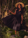 The Ambrosia Dress in Black is a masterpiece of gothic elegance. With its sleek silhouette and luxurious fabric, it whispers tales of dark romance and forbidden love, perfect for candlelit soirées.