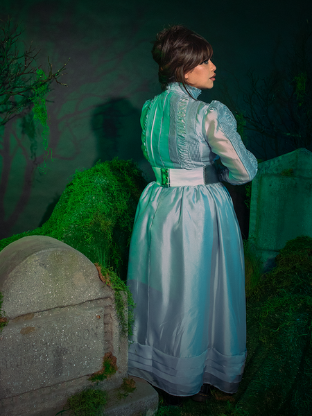 Flat lay of the dress on rich velvet, emphasizing the contrast of its crisp monochrome palette. The essence of gothic sophistication, ready to summon style.