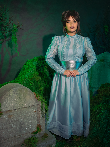 Three-quarter angle, showing the Astrid Afterlife Dress paired with black gloves and heels. A cinematic look straight from the Netherworld—bold, glamorous, unforgettable.