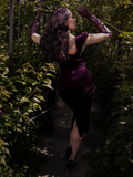 In the mirror, she wears this gothic dress like a vow—plum silk, sin, and a promise to never be forgotten.