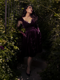 Styled with vintage gloves and a pearl necklace, the dress evokes 1950s glam with a modern fit.