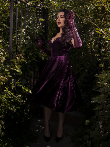A side view of the dress emphasizing the nipped-in waist and dramatic skirt volume.