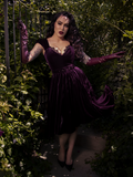 The dress glows in natural light, with autumn leaves and soft sun enhancing the romantic color.