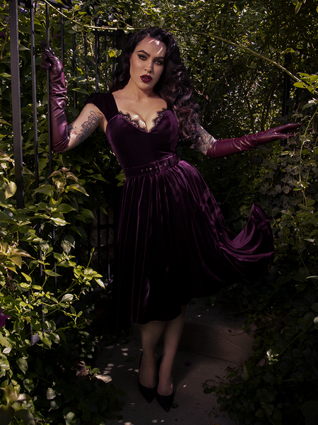 The dress glows in natural light, with autumn leaves and soft sun enhancing the romantic color.