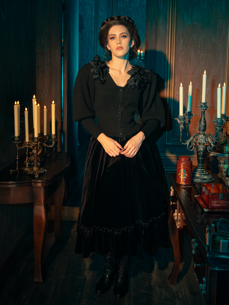 Mesmerizing models bring forth the hauntingly beautiful Victorian Velvet Bustle Skirt in Black from the gothic fashion label La Femme en Noir.