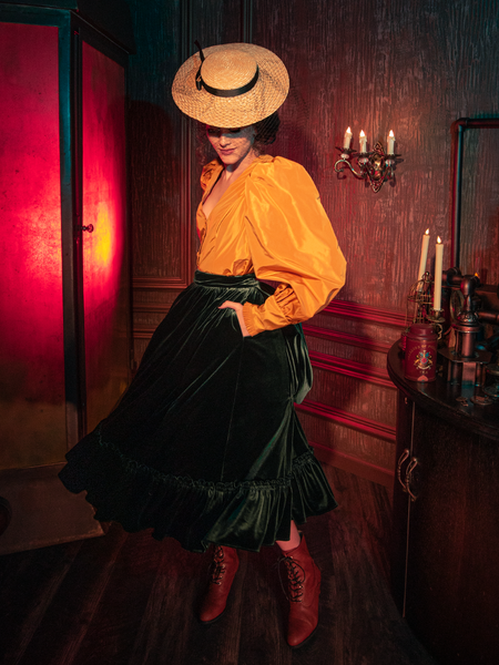 Dive into the realm of gothic aesthetics as models exhibit the hauntingly gorgeous Victorian Velvet Bustle Skirt in Olive for La Femme en Noir.