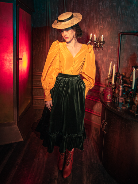 Capturing the essence of gothic sophistication, models showcase the hauntingly beautiful Victorian Velvet Bustle Skirt in Olive from La Femme en Noir.