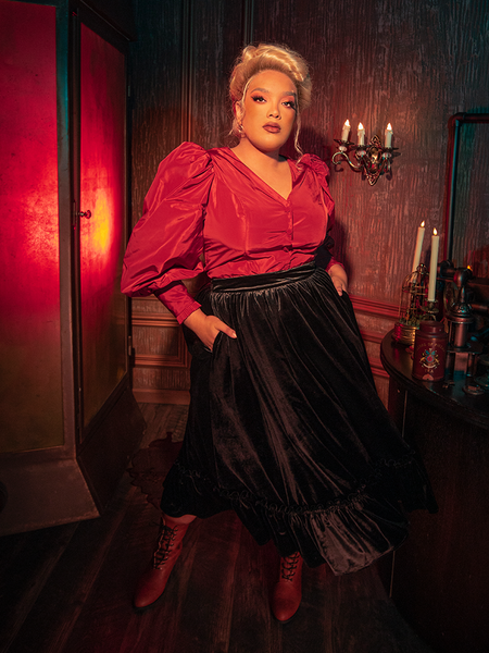 Mesmerizing the audience, models bring to life the hauntingly beautiful Victorian Velvet Bustle Skirt in Black from the gothic clothing brand La Femme en Noir.