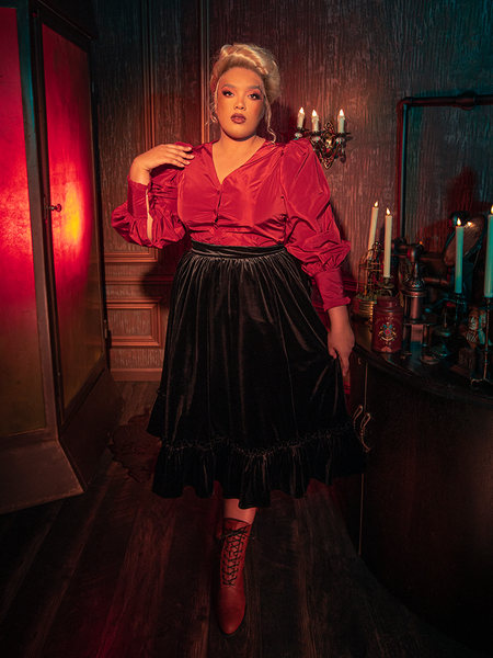 Capturing the essence of gothic sophistication, models showcase the hauntingly beautiful Victorian Velvet Bustle Skirt in Black from La Femme en Noir.