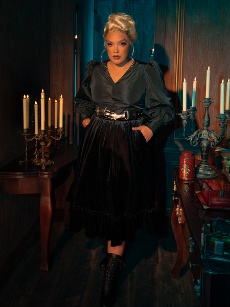 Captivating the essence of gothic elegance, models display the hauntingly gorgeous Victorian Velvet Bustle Skirt in Black for La Femme en Noir.