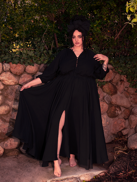 A vision of gothic clothing grace, the dress falls around her like ink soaking into velvet.