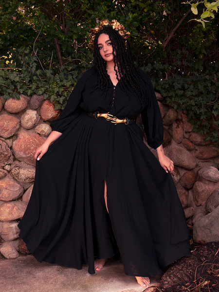 The gothic clothing ensemble is crowned with mystery, channeled through a wide-brimmed witch’s hat.