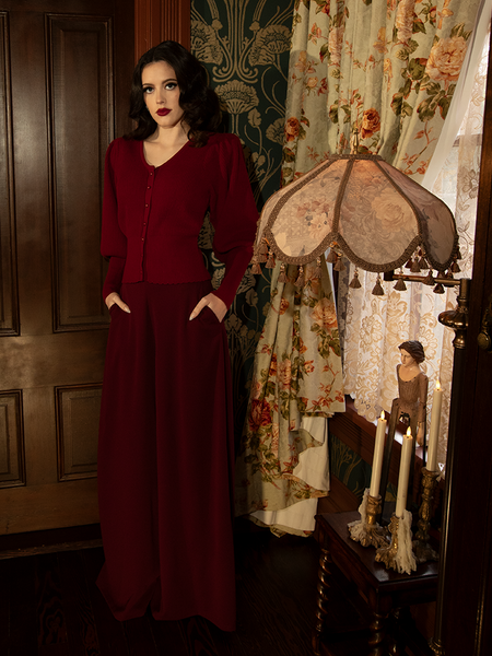 Their sweeping legs carry secrets and silence, each step a whisper in oxblood shadows that cloak your path in allure.