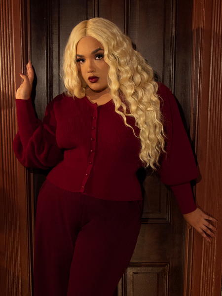 A touch of gothic grandeur, this crimson cardigan features dramatic sleeves, a sculpted bodice, and a soft, cozy knit—perfect for candlelit evenings and crisp autumn days.