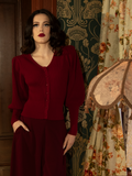 The epitome of gothic refinement, this deep crimson Victorian cardigan features dramatic puffed sleeves and intricate knit details for a striking, timeless look.