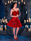 With the BRAM STOKER'S DRACULA Quilted Order of the Dragon Armor Skater Skirt in Blood Red Vegan Leather, Micheline Pitt brings a touch of gothic flair to the candle-lit dungeon, showcasing the craftsmanship of La Femme en Noir.