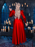 Embracing the mood of a candle-lit dungeon, a female model sets the stage for gothic fashion in the BRAM STOKER'S DRACULA Embroidered Order of the Dragon Wrap Dress in Scarlet Red, a standout piece from La Femme en Noir's gothic clothing line.