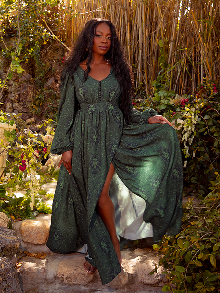 A zoomed-in shot of the plunging neckline and gathered detailing at the waist, revealing the intricacy of the Medusa-inspired design.