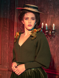 Channel the spirit of Crimson Peak with this olive Victorian cardigan. Its heavy knit and draped fit are ideal for layering, while the unique color brings a subtle yet powerful statement to your gothic style attire.