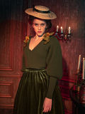 Softly lit by the last glimmers of twilight, this olive Victorian knit cardigan wraps you in warmth and mystery. Its intricate designs and olive hue reflect the shadows of the night, perfect for evening strolls through ancient landscapes.