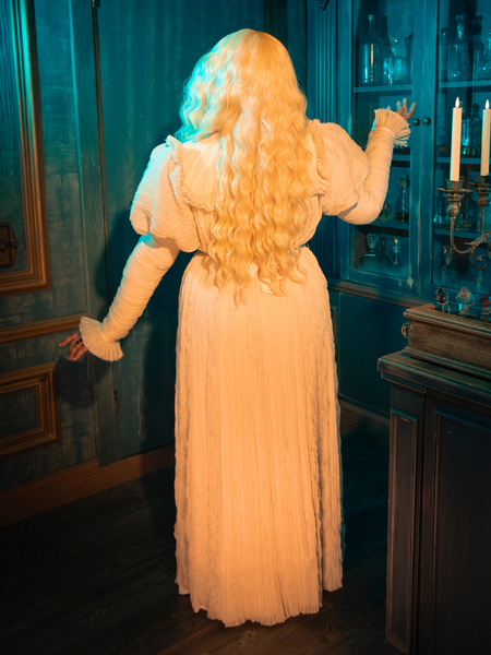 The Edith Victorian Gown in Ivory is a manifestation of spectral beauty, its pale fabric and ethereal lace reminiscent of a ghostly apparition from a love story that transcends time. Wearing this gown, one becomes the heroine of their own Gothic tale, shrouded in mystery and allure.
