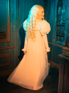 he CRIMSON PEAK™ Edith Victorian Gown in Ivory is the epitome of ethereal grace. Its flowing silhouette, adorned with handcrafted lace, seems to float around the wearer, creating an aura of mystique and elegance. This gown whispers secrets of a time when love was a grand affair, and fashion a fine art.