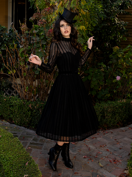 Available in sizes XS-4X, this dress honors all forms and figures, wrapping each wearer in shadowed sophistication.