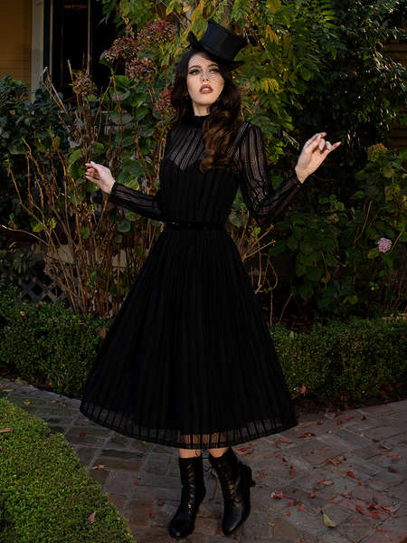 Easy-care fabric allows for gentle machine wash or delicate hand-cleaning, preserving its dark beauty for many occasions.