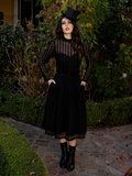 Cinched at the waist, the dress embraces curves with subtle strength—an ode to feminine power in moments of loss.