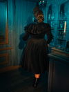 Enveloped in the night, the Victorian Mourning Dress with Capelet in Black is a fortress for the soul. Its fabric, rich and deep, serves as armor, while the capelet, light and ethereal, whispers of vulnerabilities cherished and protected.