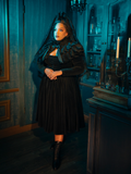 Wearing the Haunted Beauty ensemble, you are a portrait in black, a living masterpiece framed by the intricate details of Victorian mourning attire. The capelet adds a touch of mystery, a veil between you and the world, inviting intrigue and admiration.