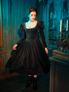 Ideal for those moments when one wishes to be enveloped in the beauty of the night, the Haunted Beauty Victorian Mourning Dress with Capelet in Black offers not just a garment, but a portal to a world where darkness and elegance reign supreme.