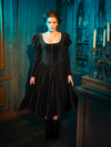 The Haunted Beauty Victorian Mourning Dress finds beauty in bereavement. Its capelet, a delicate touch amidst the sorrow, adds a layer of sophistication and depth, proving that even in mourning, there is a place for beauty.