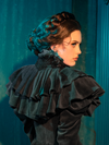 This mourning dress is a game of Victorian shadowplay, its capelet the curtain behind which emotions play out. The intricate designs and somber hue invite onlookers into a world where fashion is a form of expression, as profound and moving as any artwork.
