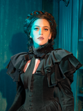 The Haunted Beauty Victorian Mourning Dress, complemented by its ethereal capelet, serves as a shroud of memories. It is an ensemble that carries the whispers of the past, each thread a reminder of the beauty found in remembrance.