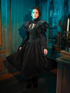 Wearing the Victorian Mourning Dress, you conduct a silent symphony of style and sorrow. The capelet adds a layer of complexity, a subtle nuance that speaks volumes in the quietest of whispers.