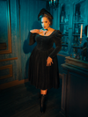 This Victorian Mourning Dress embodies darkness, its capelet a veil between worlds. It is a garment that honors the past, embracing the solemn beauty of mourning while casting the wearer as the protagonist in their own gothic tale.