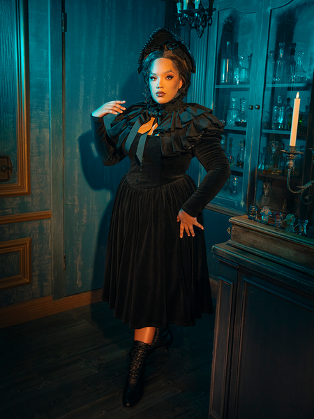 This dress is an echo of eternity, a reminder that beauty can be found even in the darkest of times. The capelet, soft and embracing, is a testament to the enduring power of love and remembrance.