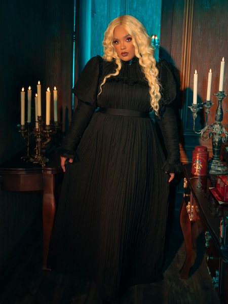 Indulge in the dark decadence of the Lady Mourning Victorian Gown. This masterpiece is a blend of opulent velvet and ethereal lace, creating a stunning contrast that captures the essence of gothic glamour.