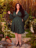 Slink into this faux wrap dress, its Medusa-inspired print a tribute to mystique and power. The draped design flatters the figure, offering an effortless mix of drama and comfort for bold spirits.