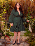 A celebration of gothic glamour, this Medusa-print faux wrap dress entices with its dramatic allure. The lightweight fabric and flattering fit promise endless versatility, from twilight dinners to gallery galas.